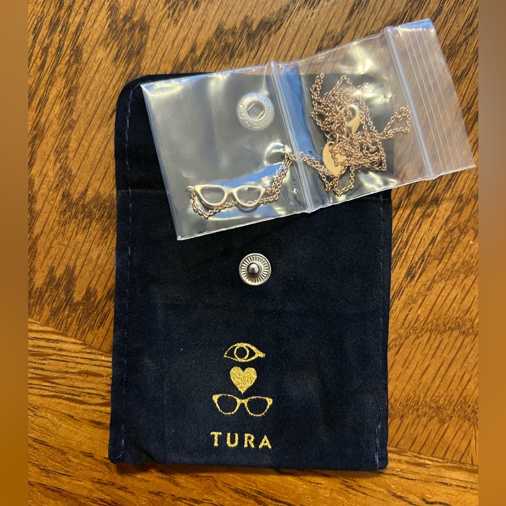 Brand new, gold eyeglasses necklace with necklace pouch.